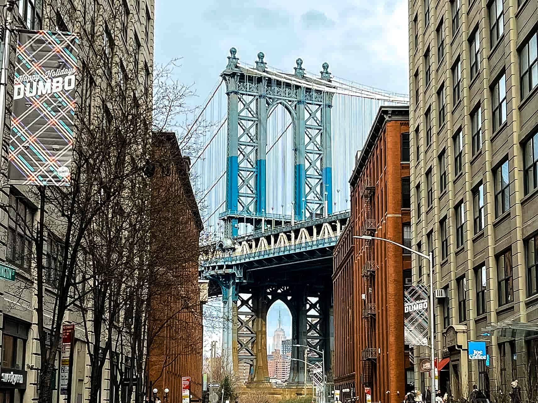 New York City in Winter - A Guide to Visiting New York City in Winter Manhattan Bridge with a view of the Empire State Building in Dumbo - New York City, USA.