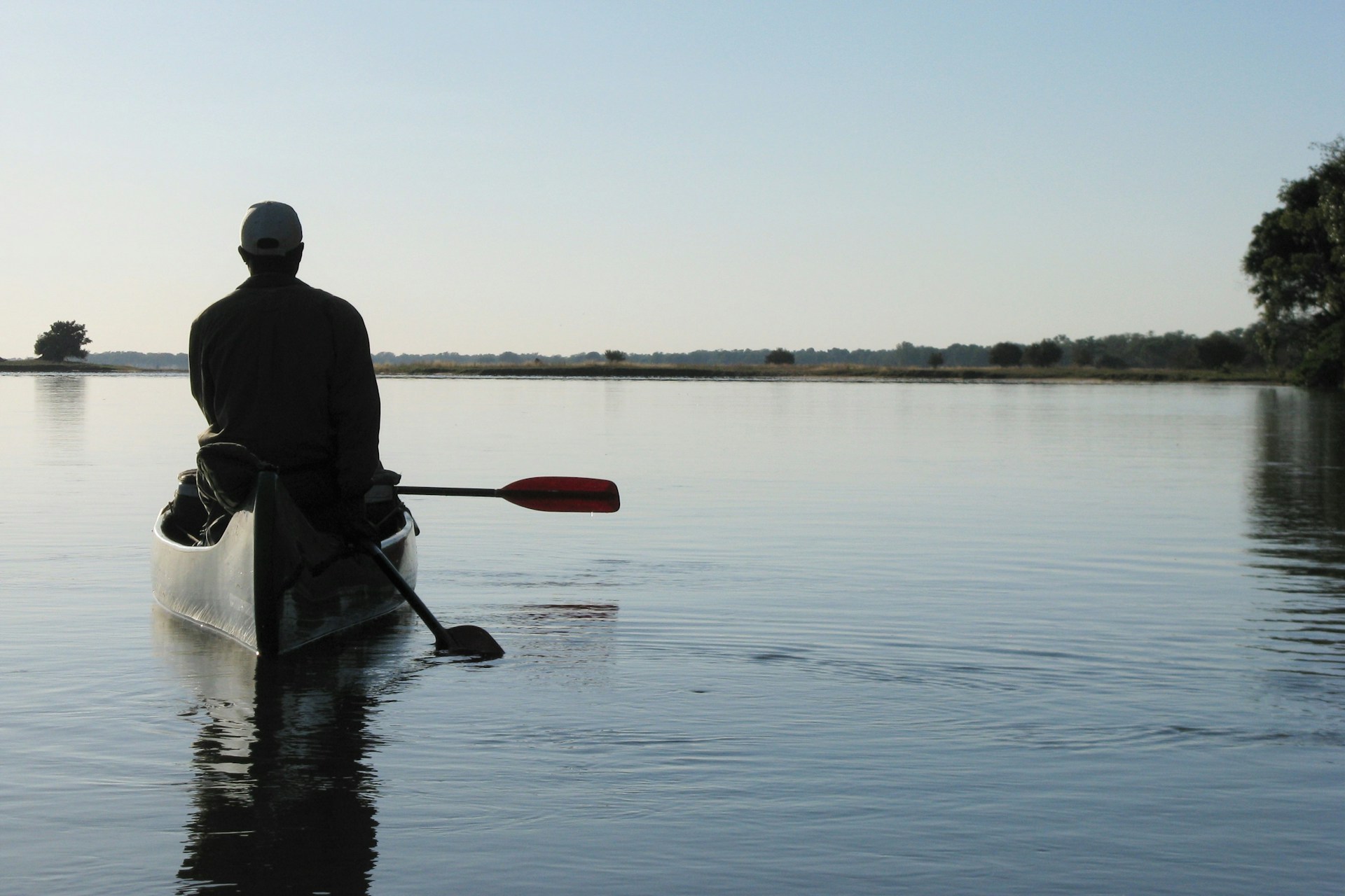 Lower Zambezi National Park - A Guide to Visiting Lower Zambezi National Park Person on a canoe in the Zambezi River, Zambia